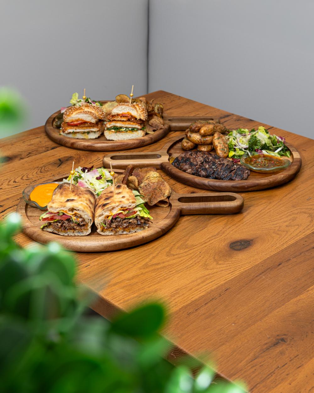 Sandwiches and plates on a wooden table