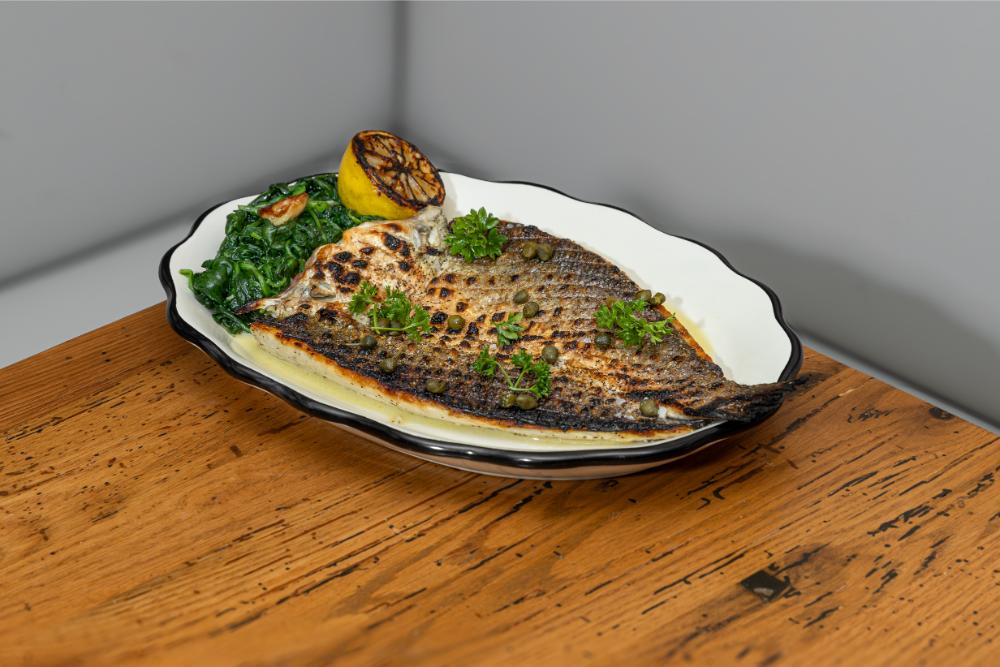Whole fish entrée plated for service